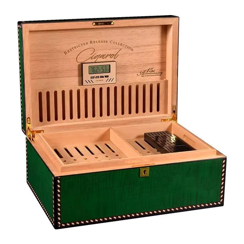 Open green cigar humidor with a built-in digital hygrometer, showcasing cedar wood interiors and divided compartments for cigar storage.