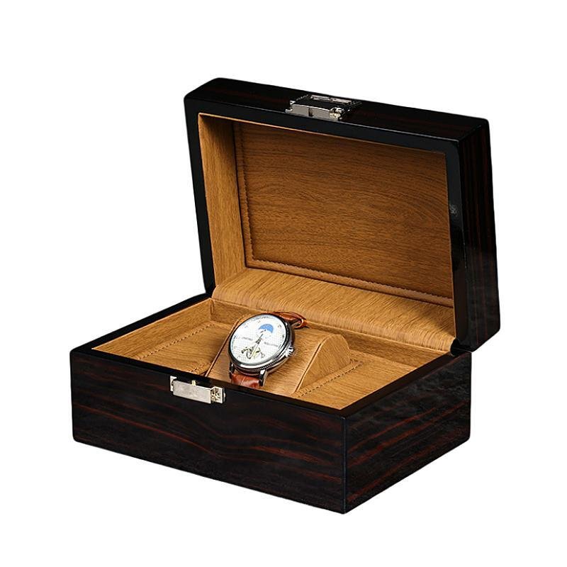 Black wooden watch box with a high-gloss finish, soft inner lining, and a single watch compartment for secure storage.