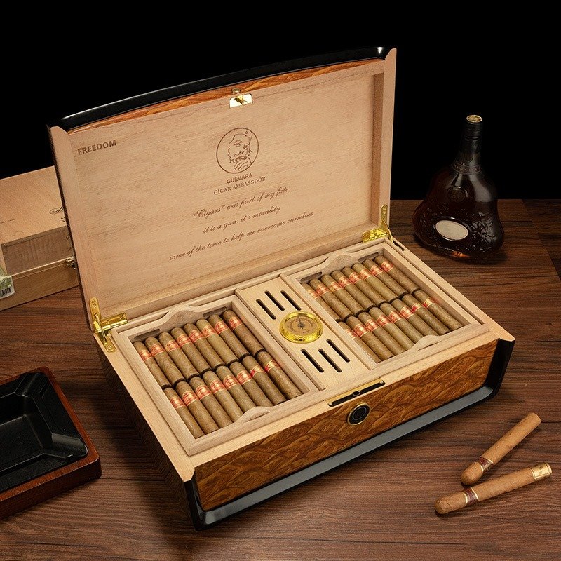 Open premium wooden cigar humidor featuring a hygrometer, dual storage compartments, and neatly arranged cigars.