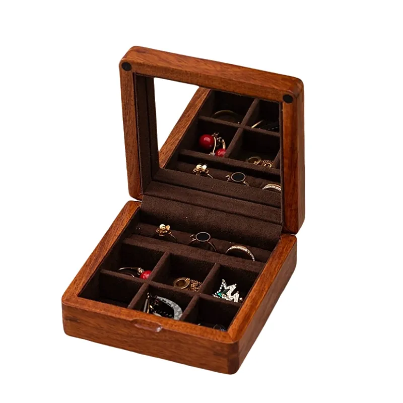 Small wooden jewelry box with a built-in mirror, soft velvet lining, and multiple compartments for rings and earrings.