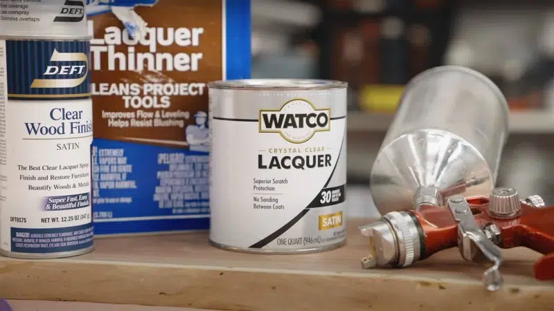 Spraying lacquer over wide wooden panel