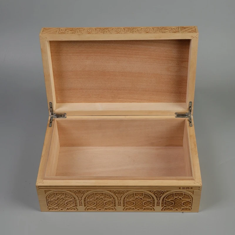 Open wooden cigar box with carved design