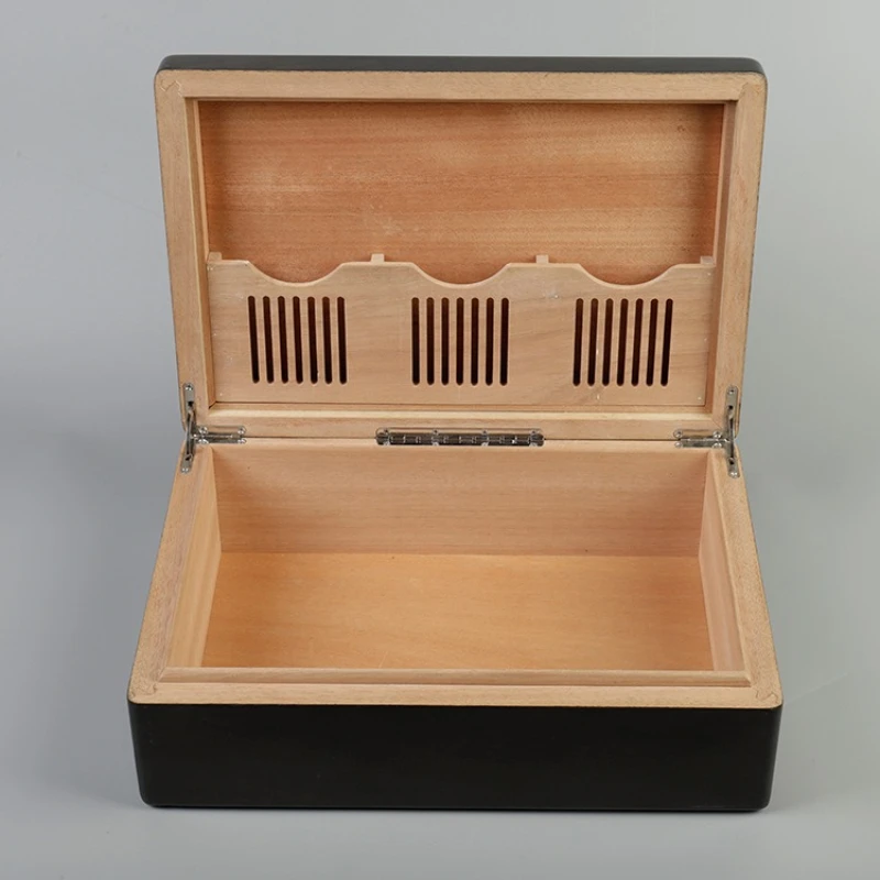 Open wooden cigar humidor with slotted lid panel