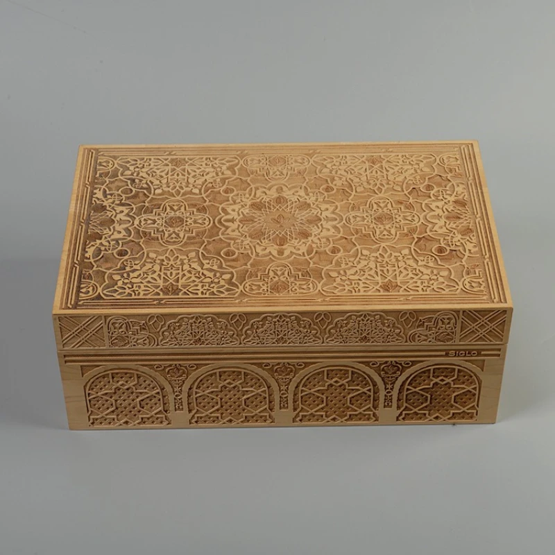 Closed carved wooden cigar humidor with ornate pattern