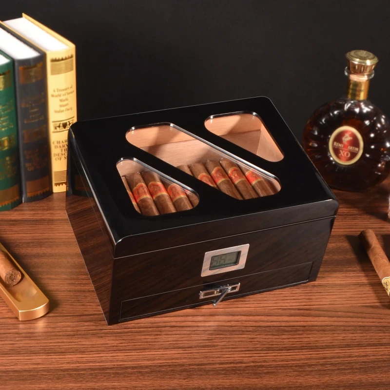 Closed glass top cigar humidor with cigars and digital display