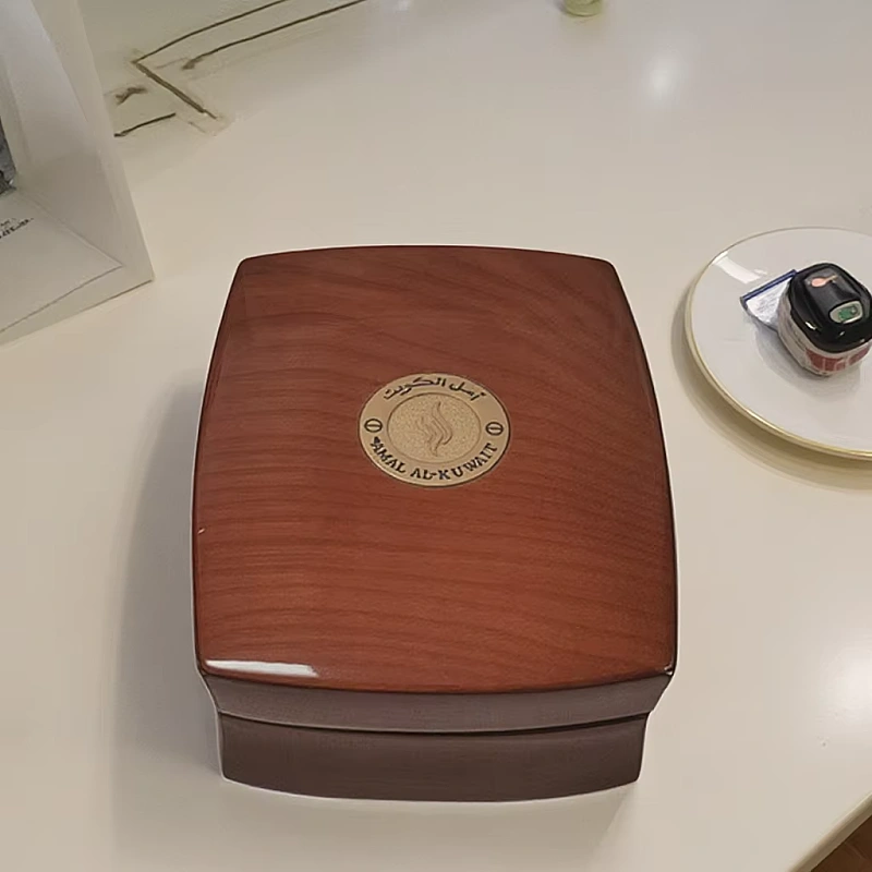 Closed Shamal Al-Kuwait wooden perfume box on table