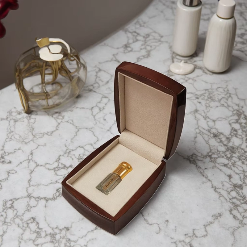 Mini perfume bottle in wooden box on marble counter