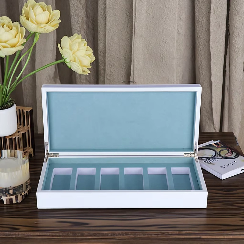 White perfume box with six blue compartments
