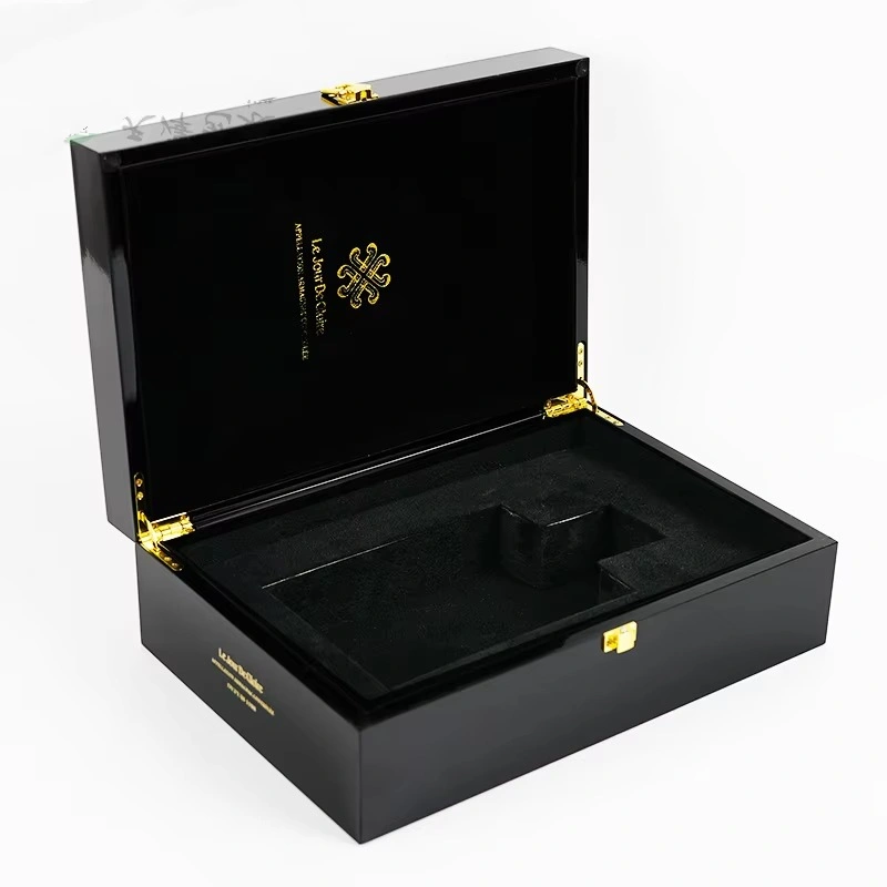 Open black whisky box with gold hinges and velvet insert
