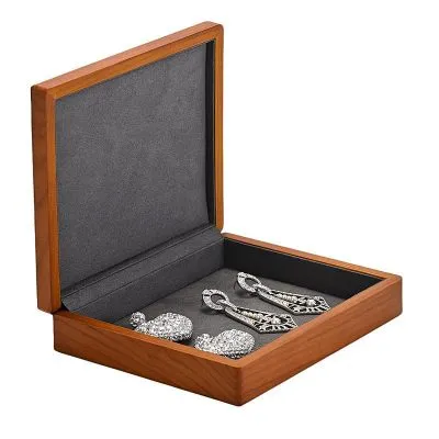 Compact wooden jewelry box with a soft velvet interior, showcasing earrings and brooches.